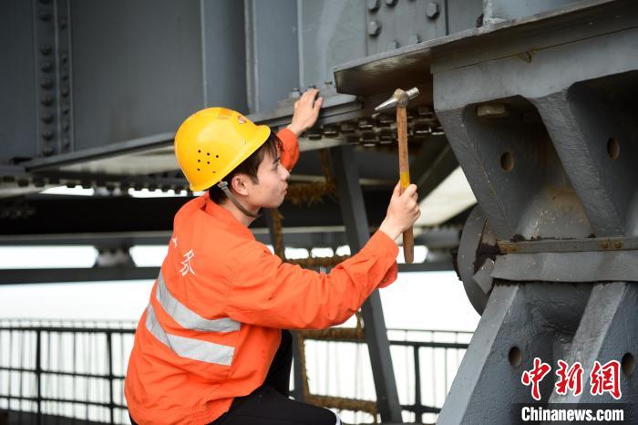 6月24日，南鐵九江橋工段的橋梁工正在九景衢鐵路鄱陽湖大橋上對高強度螺栓進行檢查更換。　 黃旸 攝