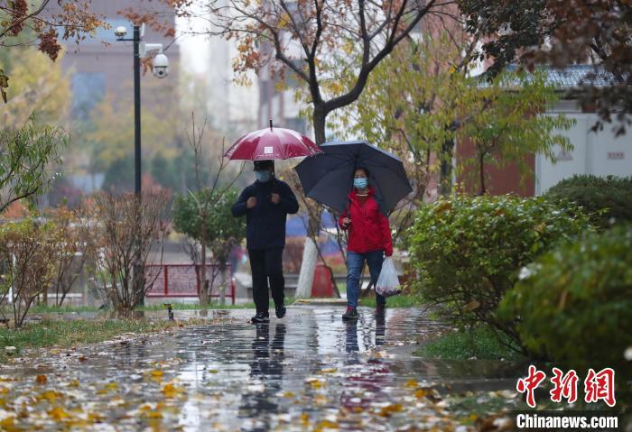 資料圖：市民雨中出行?！∮诰?攝