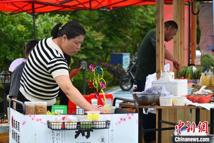 上金貝村村民擺攤售賣畬族美食?！∮嗌强?攝