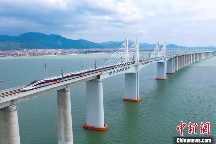 9月28日，復(fù)興號智能動車組行駛在福廈高鐵湄洲灣跨海大橋。歷經(jīng)6年多時間建設(shè)，全長277公里的福廈高鐵，穿越多處山脈，跨越多處海灣，將難上九重天的閩道與大海緊緊相連。李響攝